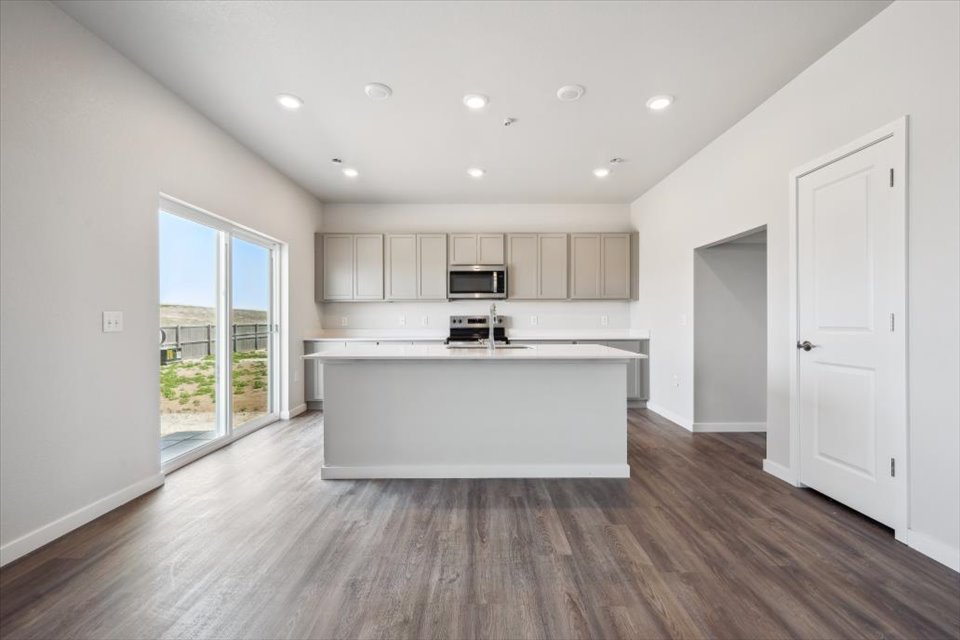 A kitchen with white cabinets.