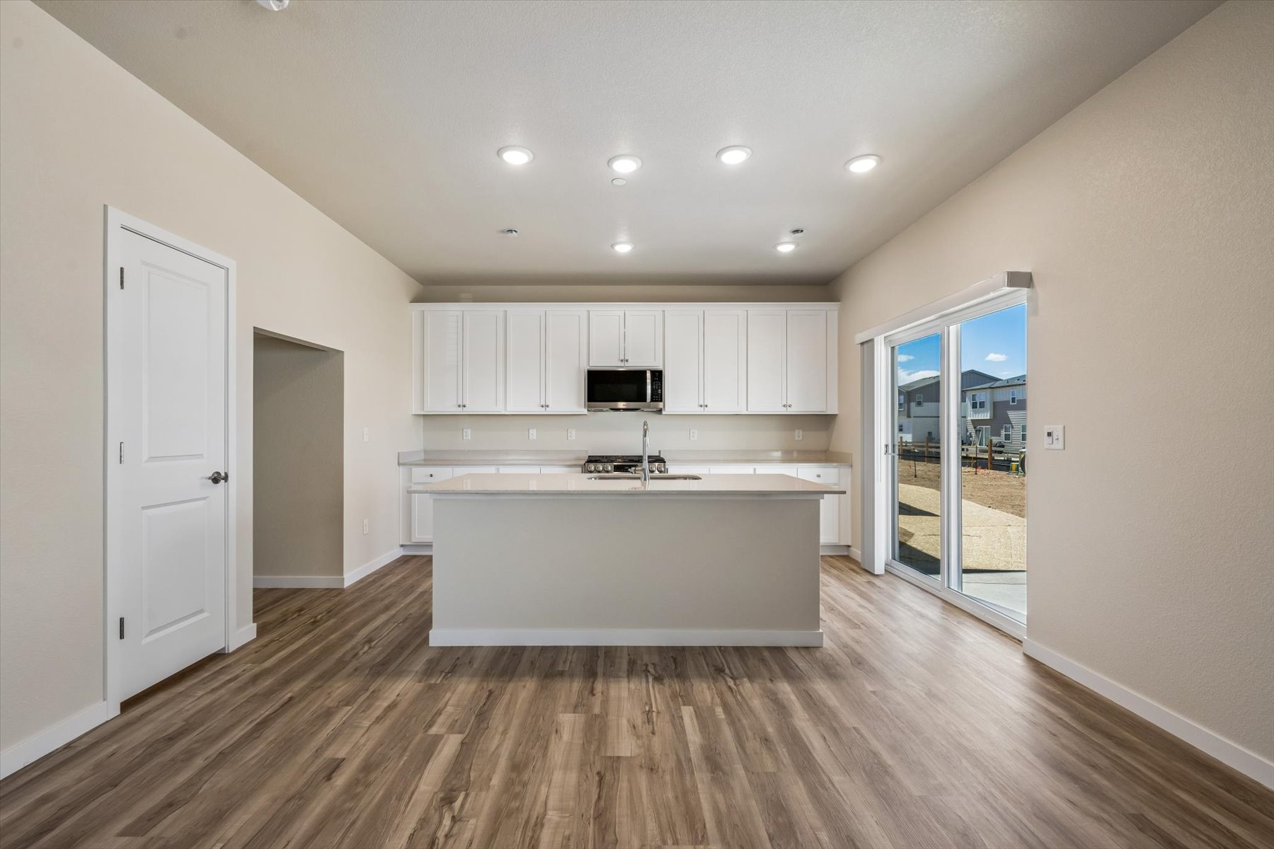 A kitchen with white cabinets.