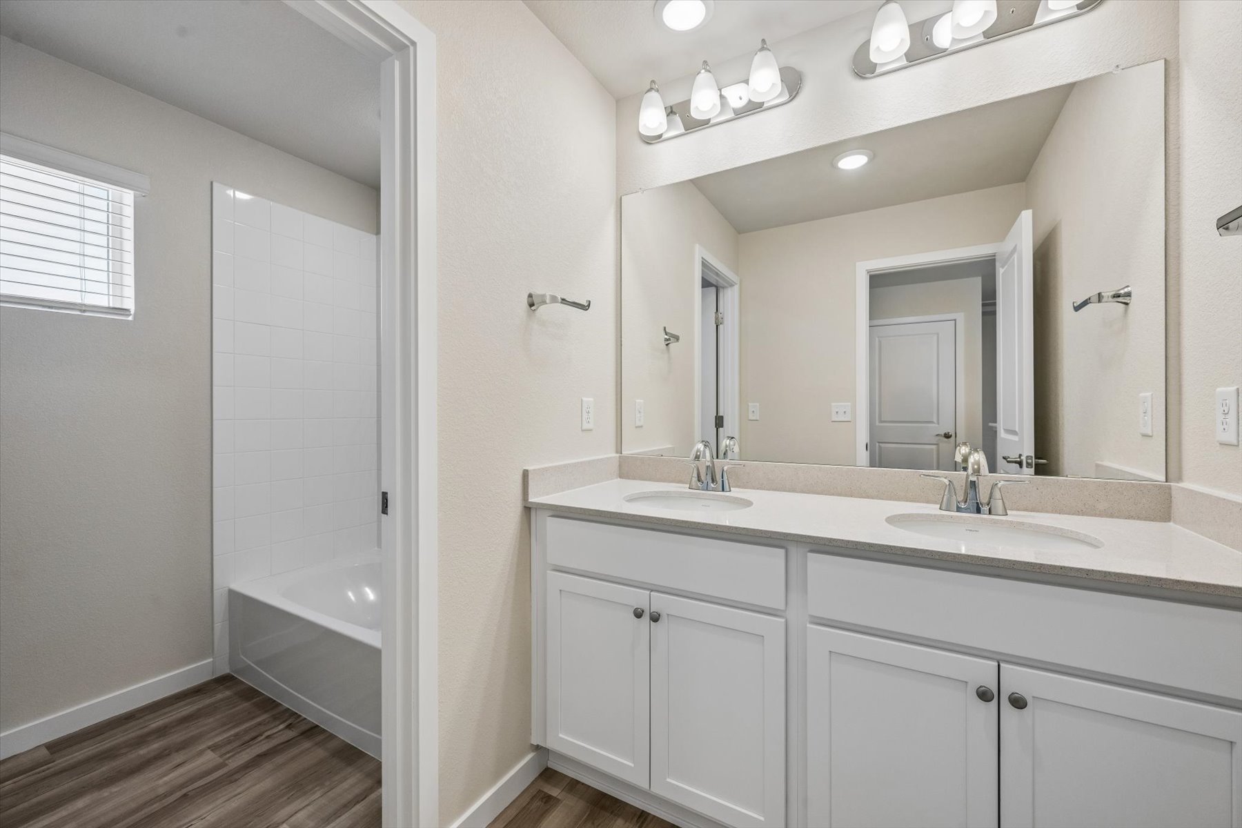 A bathroom with a tub sink and a shower.