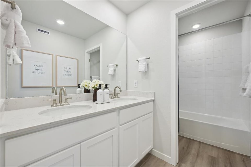 A bathroom with a sink and a shower.