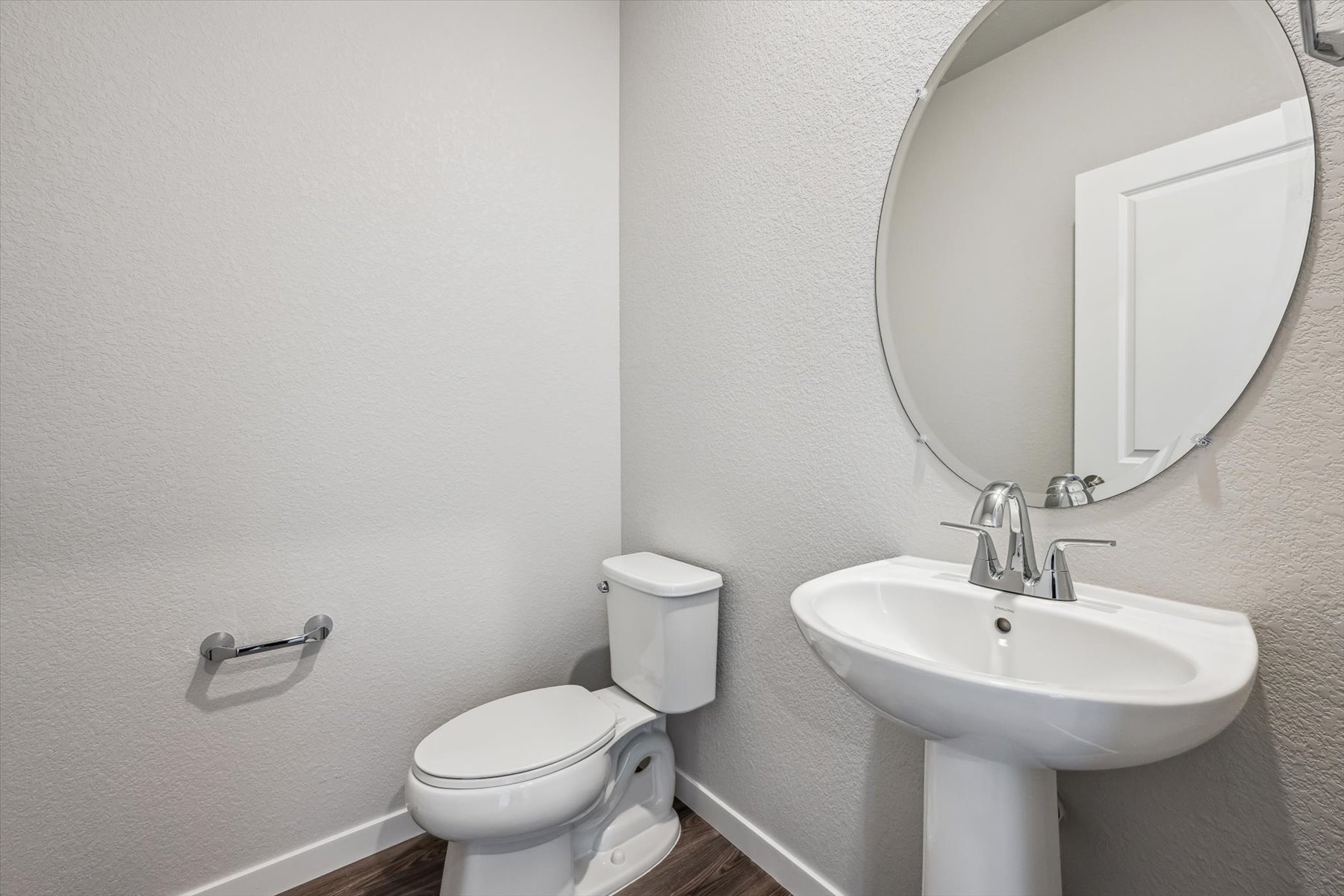 A bathroom with a toilet and sink.