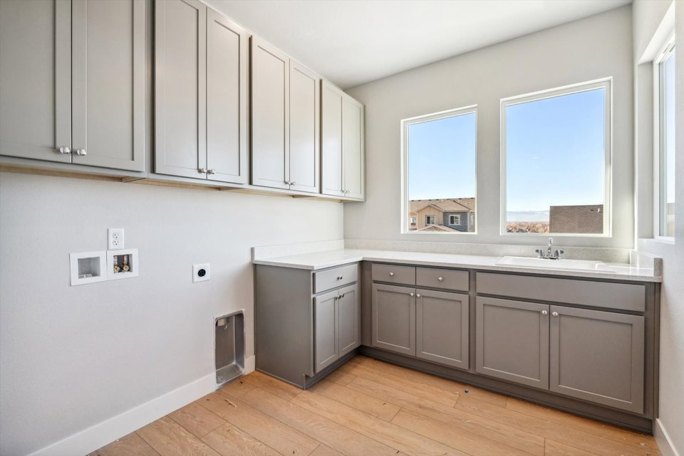 A kitchen with white cabinets.