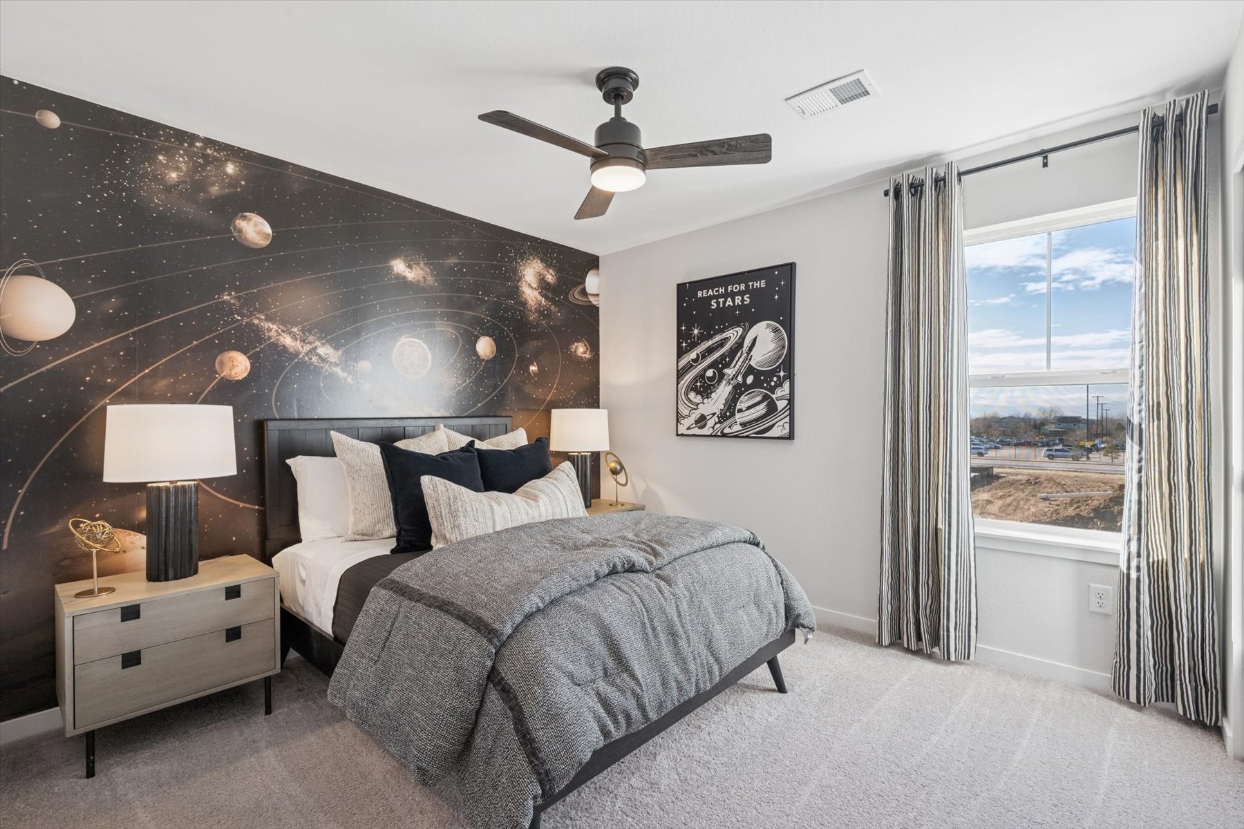 A bedroom with a large window.