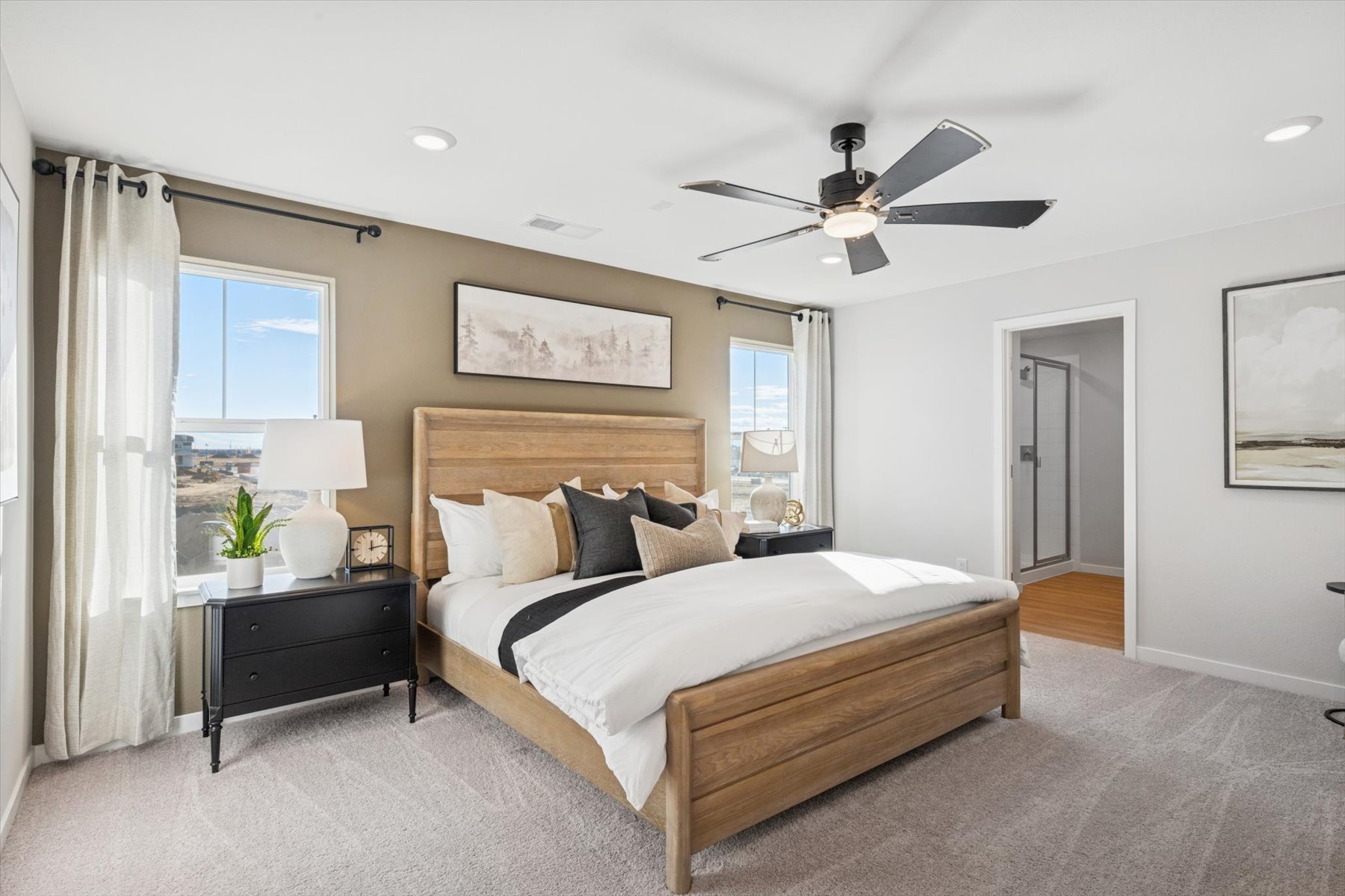 A bedroom with a bed and a fan.