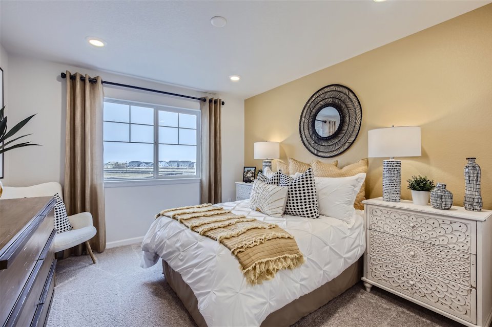 A bedroom with a bed and a desk.