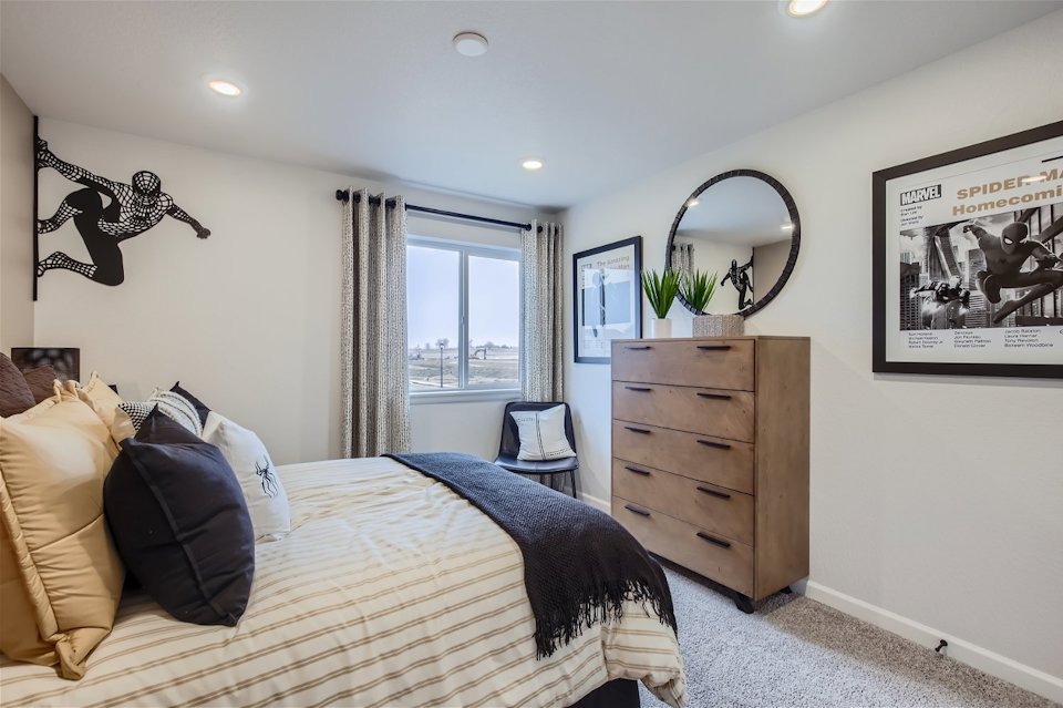 A bedroom with a large mirror.