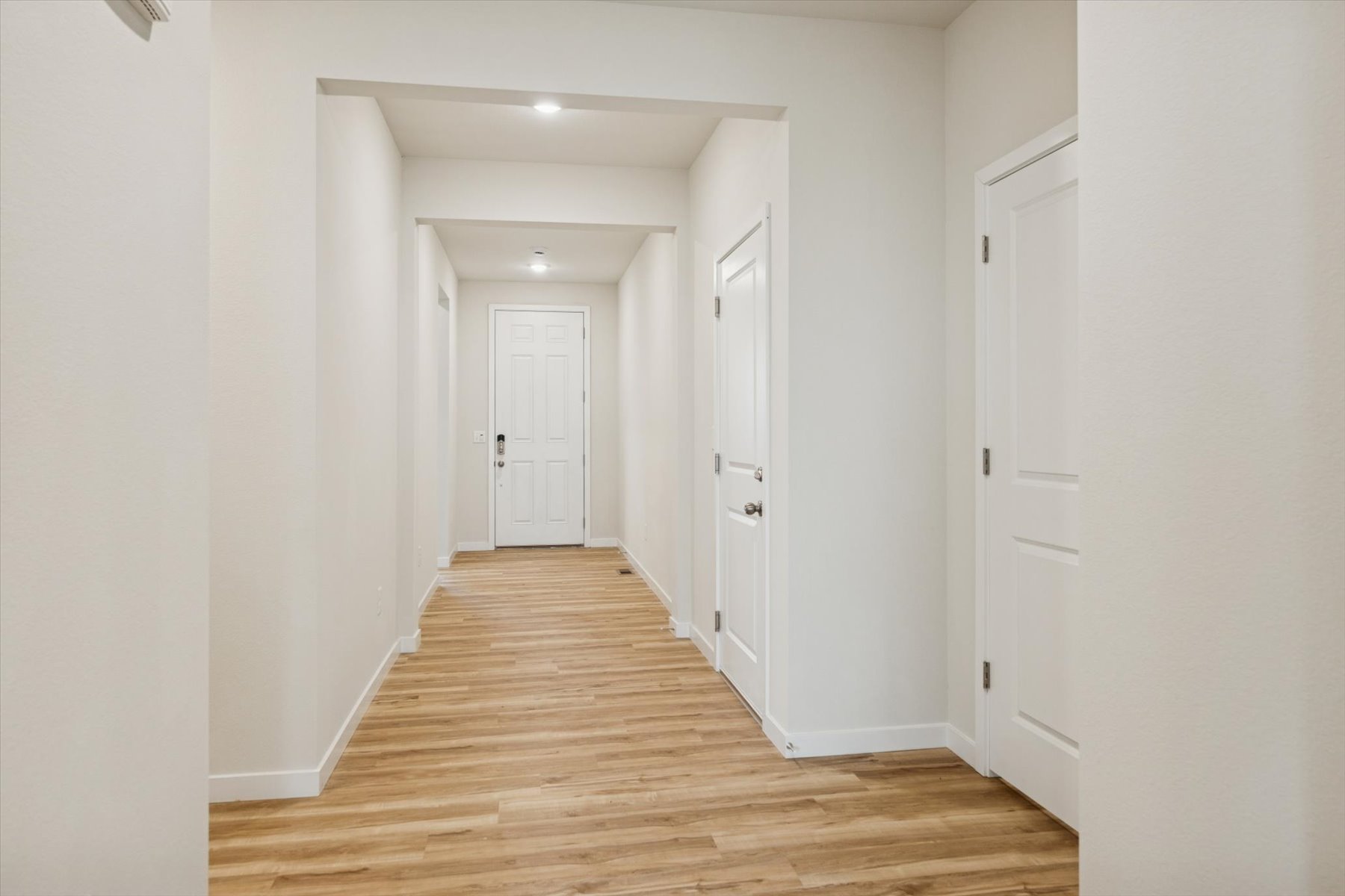 A hallway with white doors.