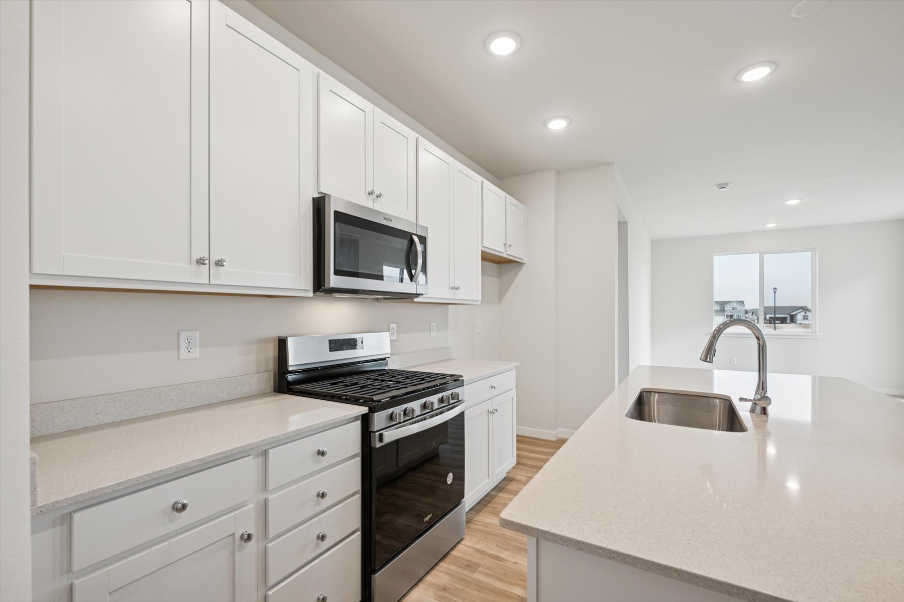A kitchen with white cabinets.