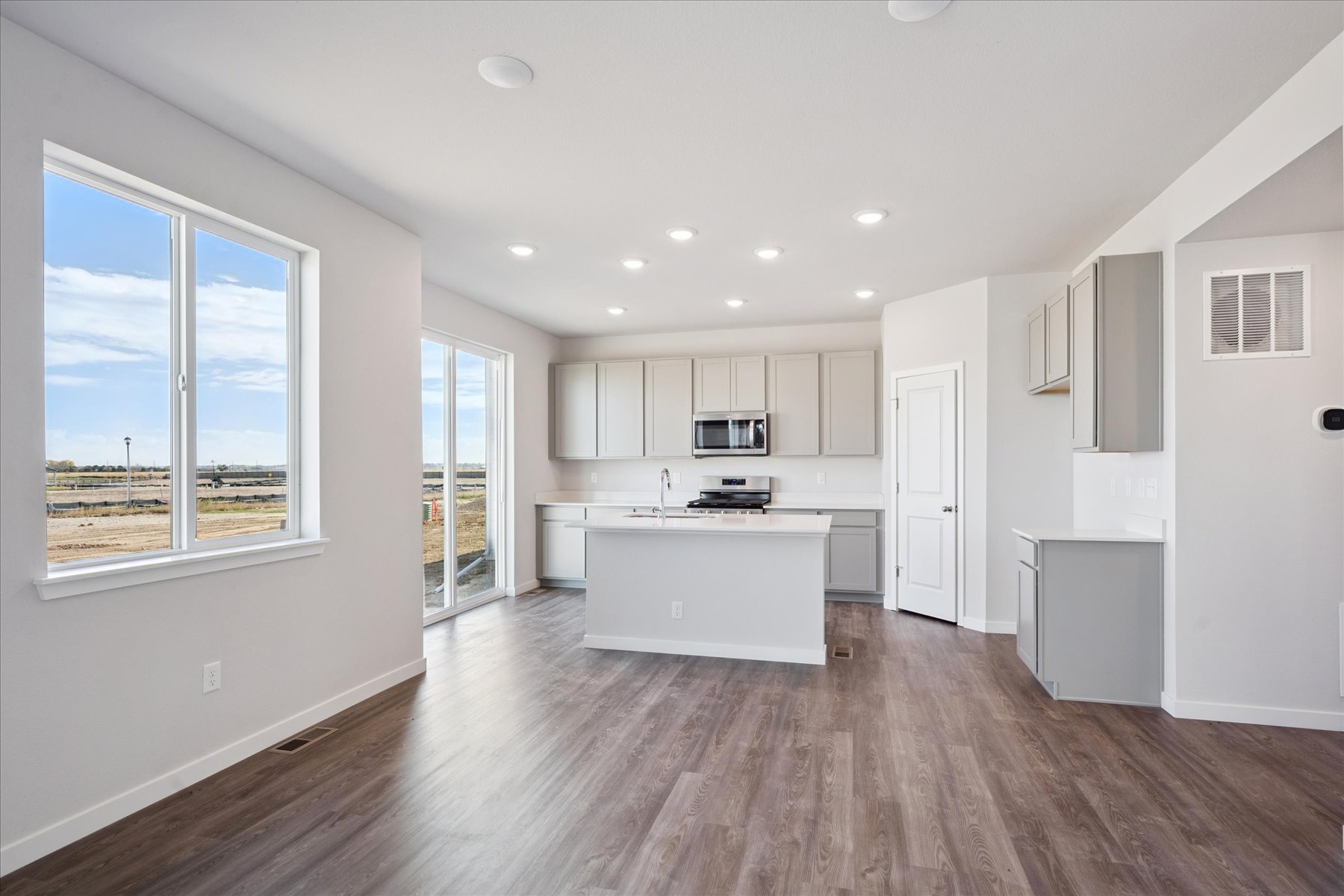 A large kitchen with white cabinets.