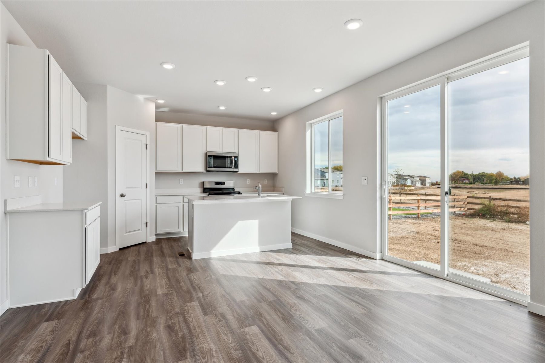 A kitchen with white cabinets.