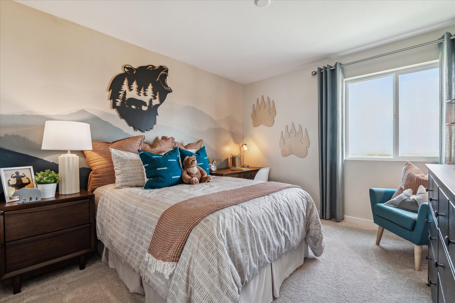 A bedroom with a bed and a chair.