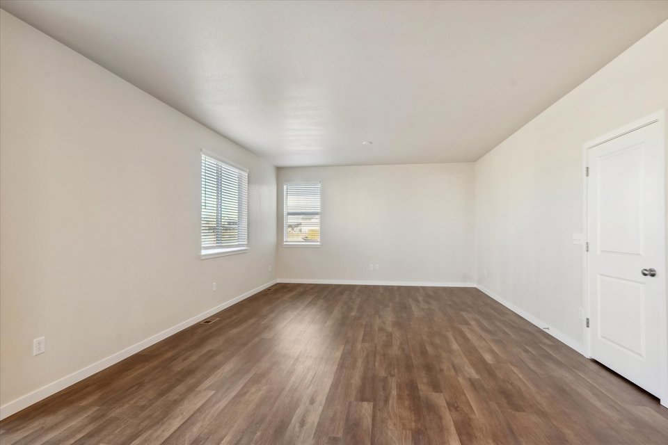 A room with white walls and a wood floor.