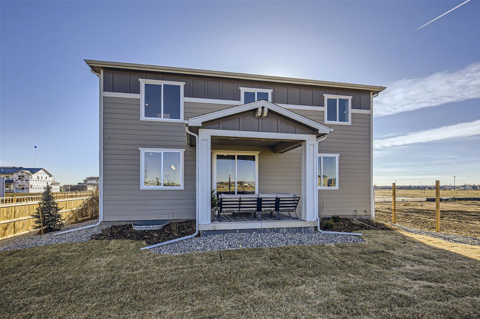 A house with a bench in the front.