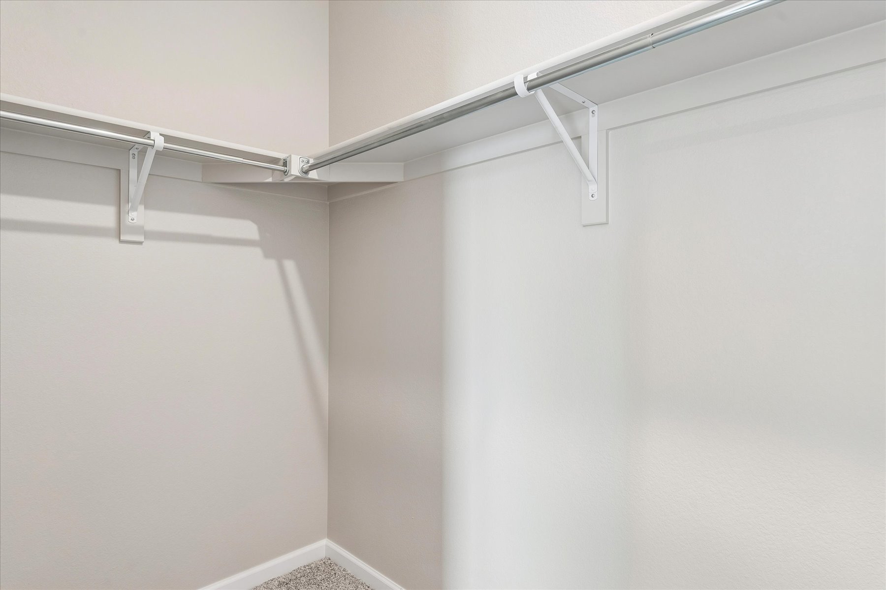 A white ceiling with a metal railing.