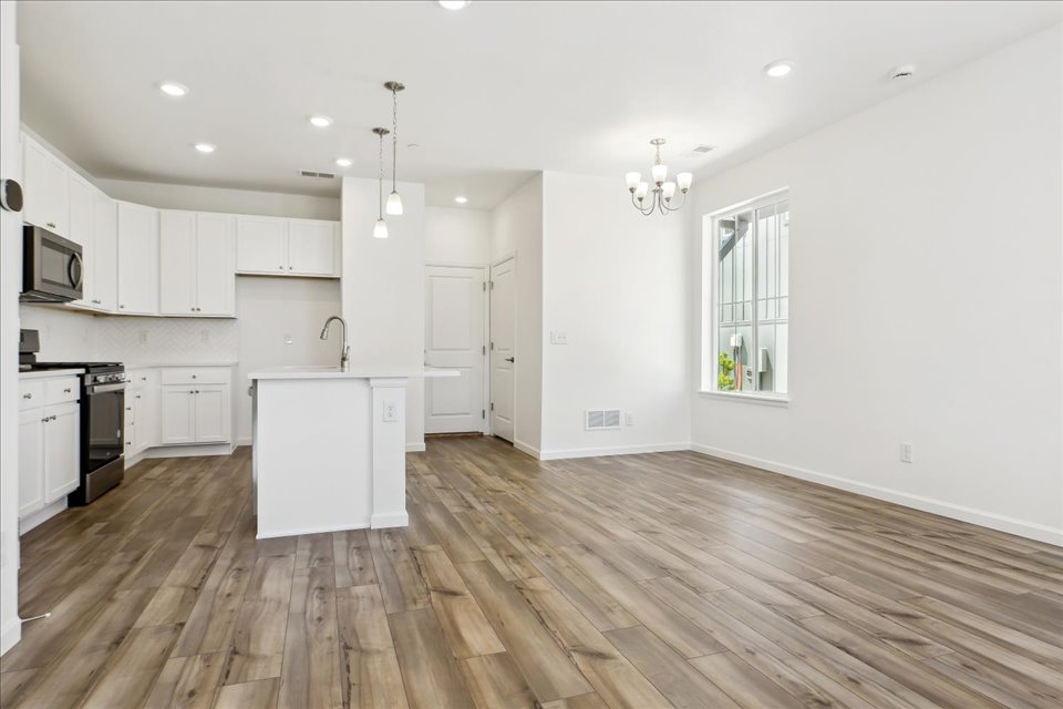 A kitchen with white cabinets.