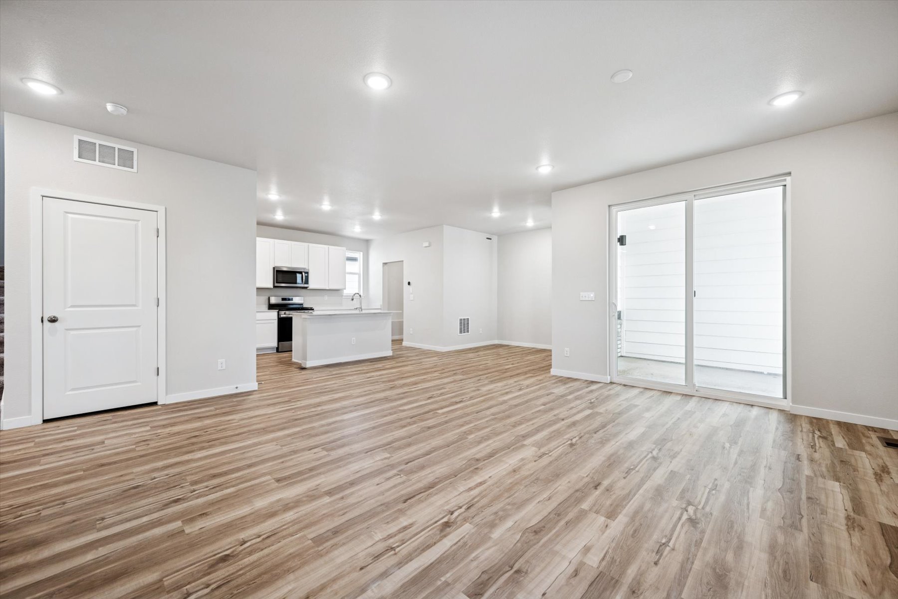 A large empty room with white doors.