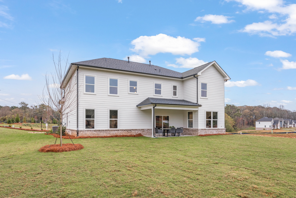 A house with a lawn in front of it.