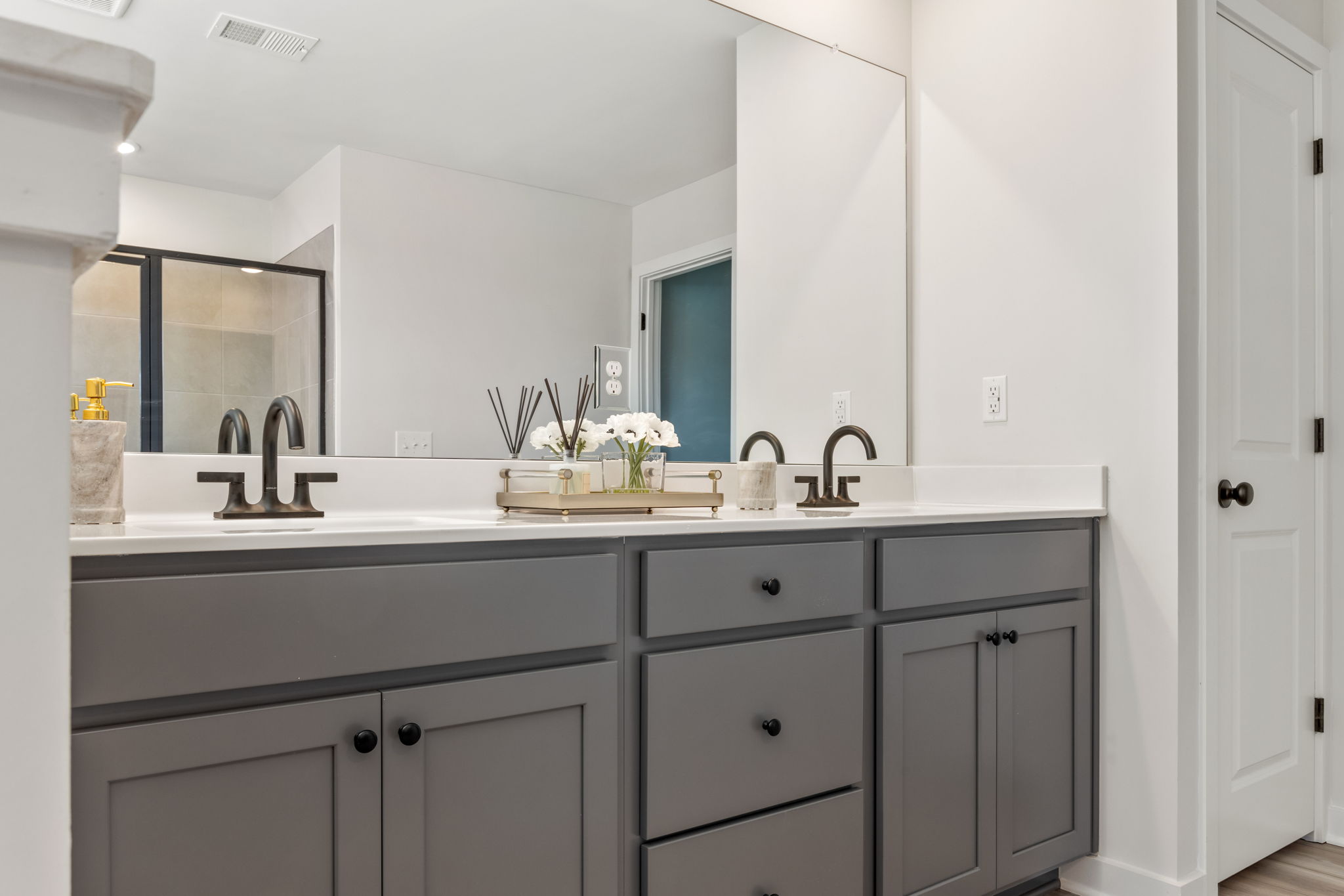 A bathroom with white cabinets.