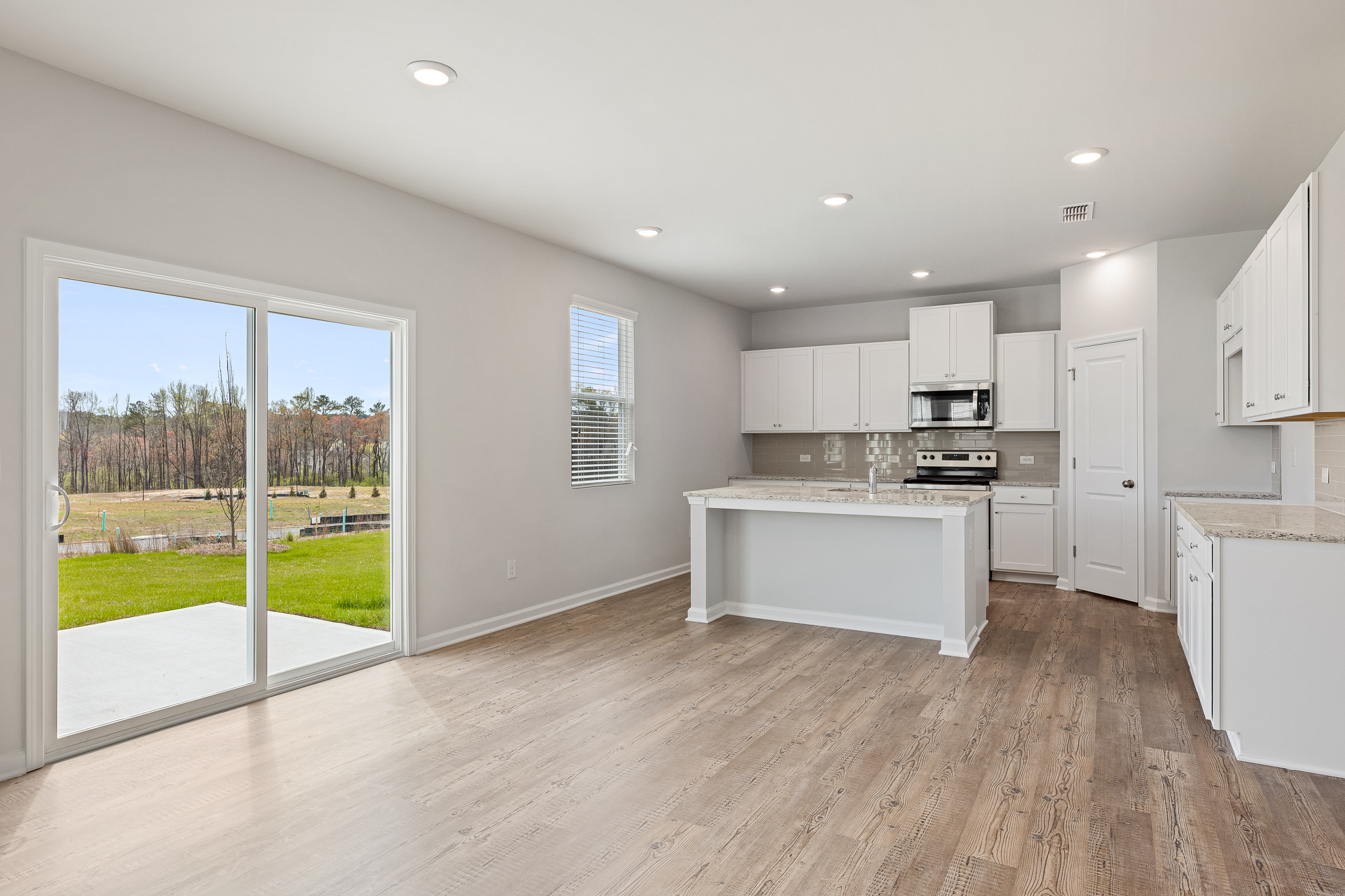 A kitchen with white cabinets.