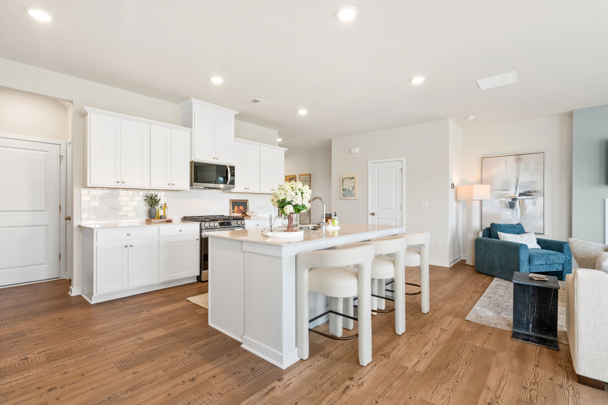 A kitchen with white cabinets.