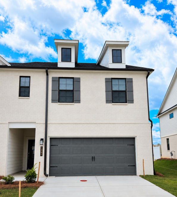 A white house with a garage.