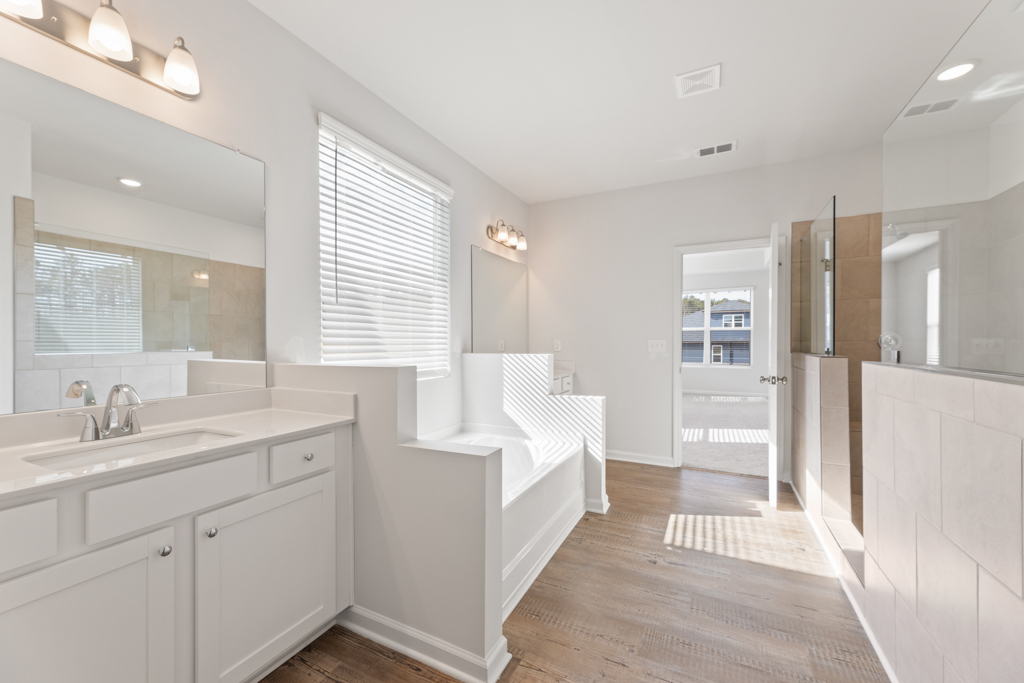 A bathroom with white cabinets.