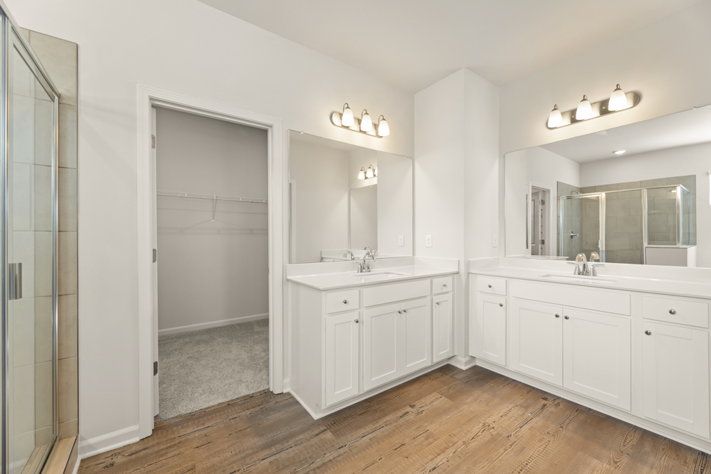 A bathroom with white cabinets.