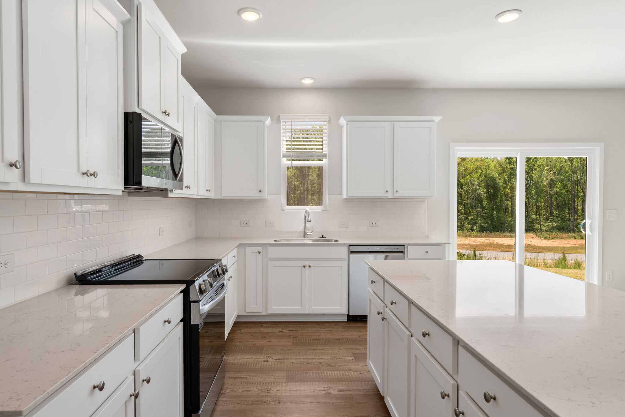 A kitchen with white cabinets.