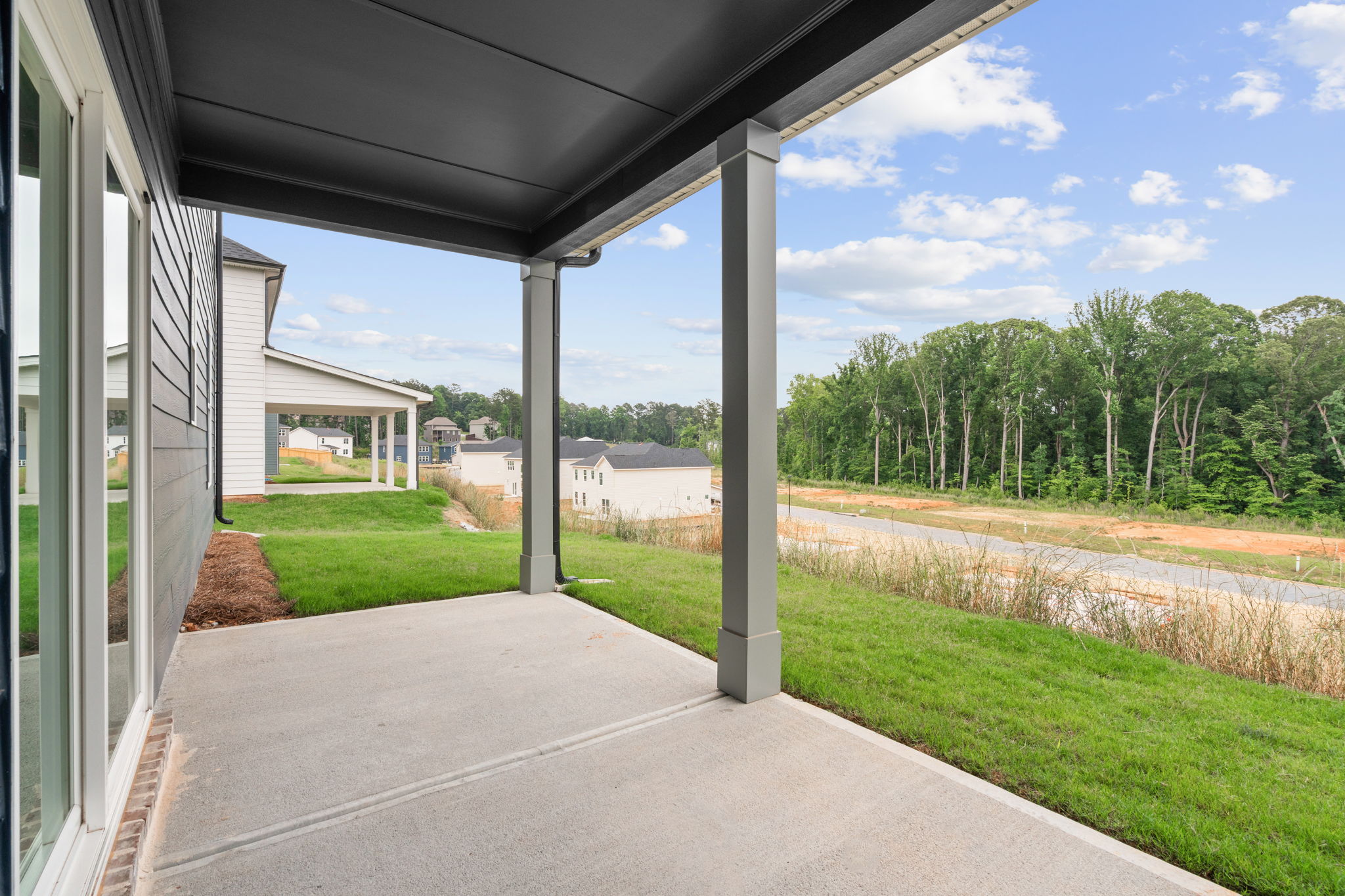 A building with a walkway and grass.