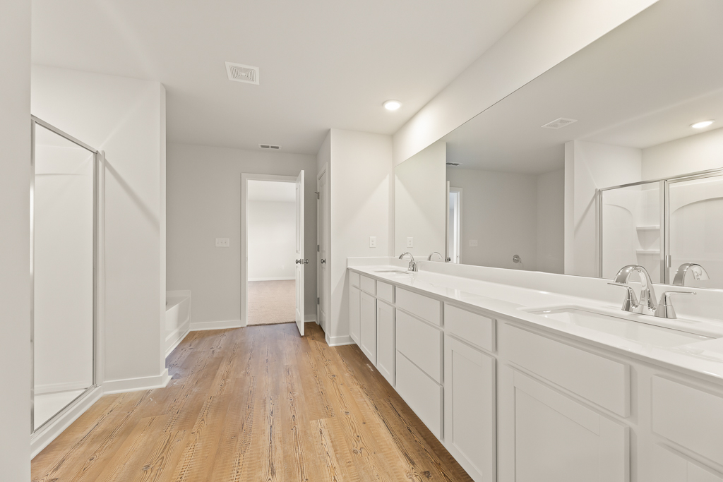 A bathroom with white cabinets.
