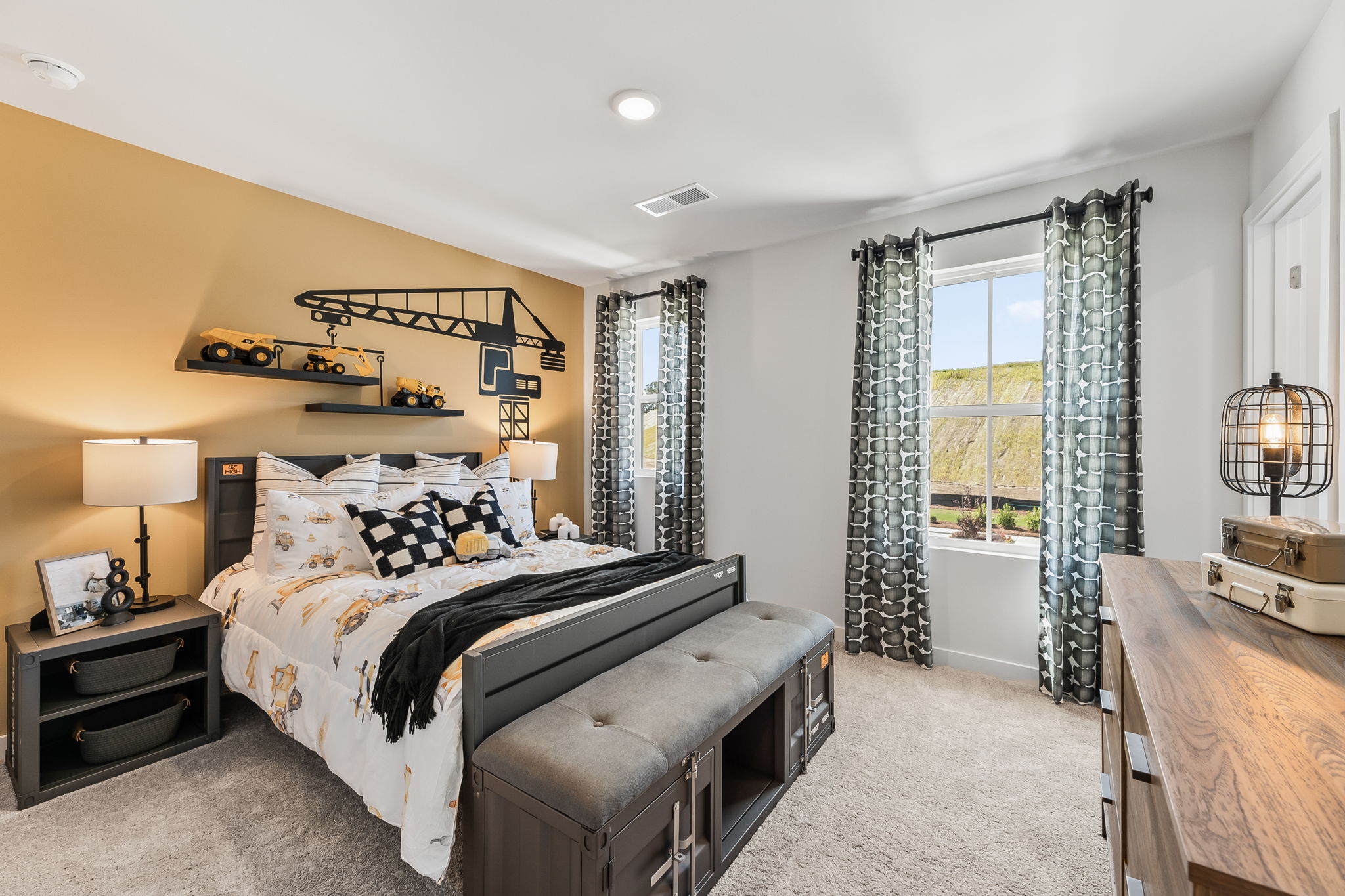 A bedroom with a bed and a bench.