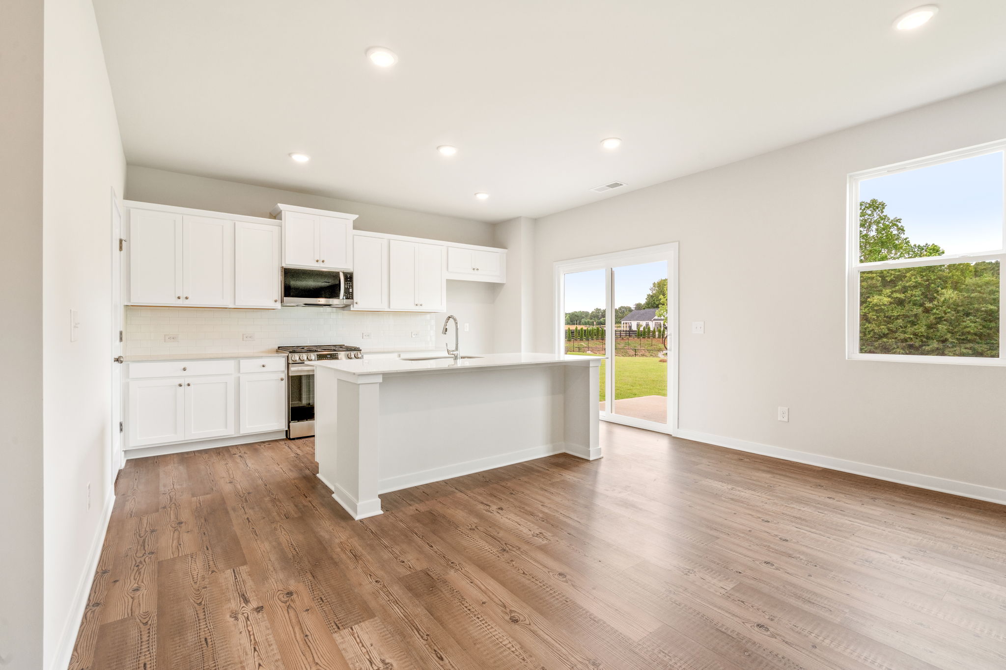 A kitchen with white cabinets.