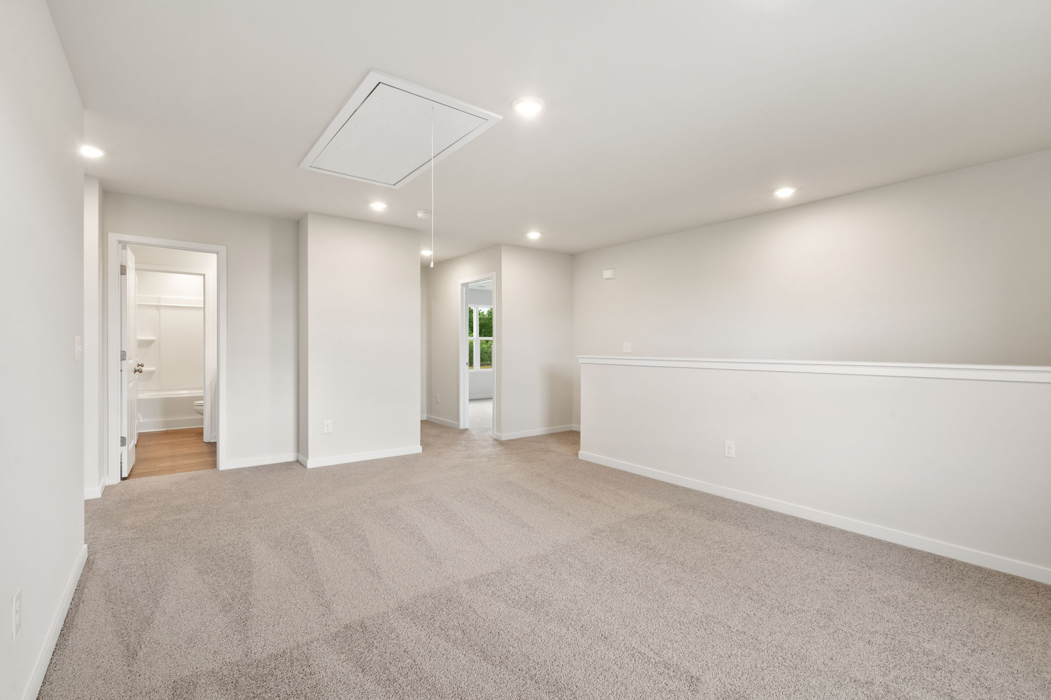 A long hallway with white walls.