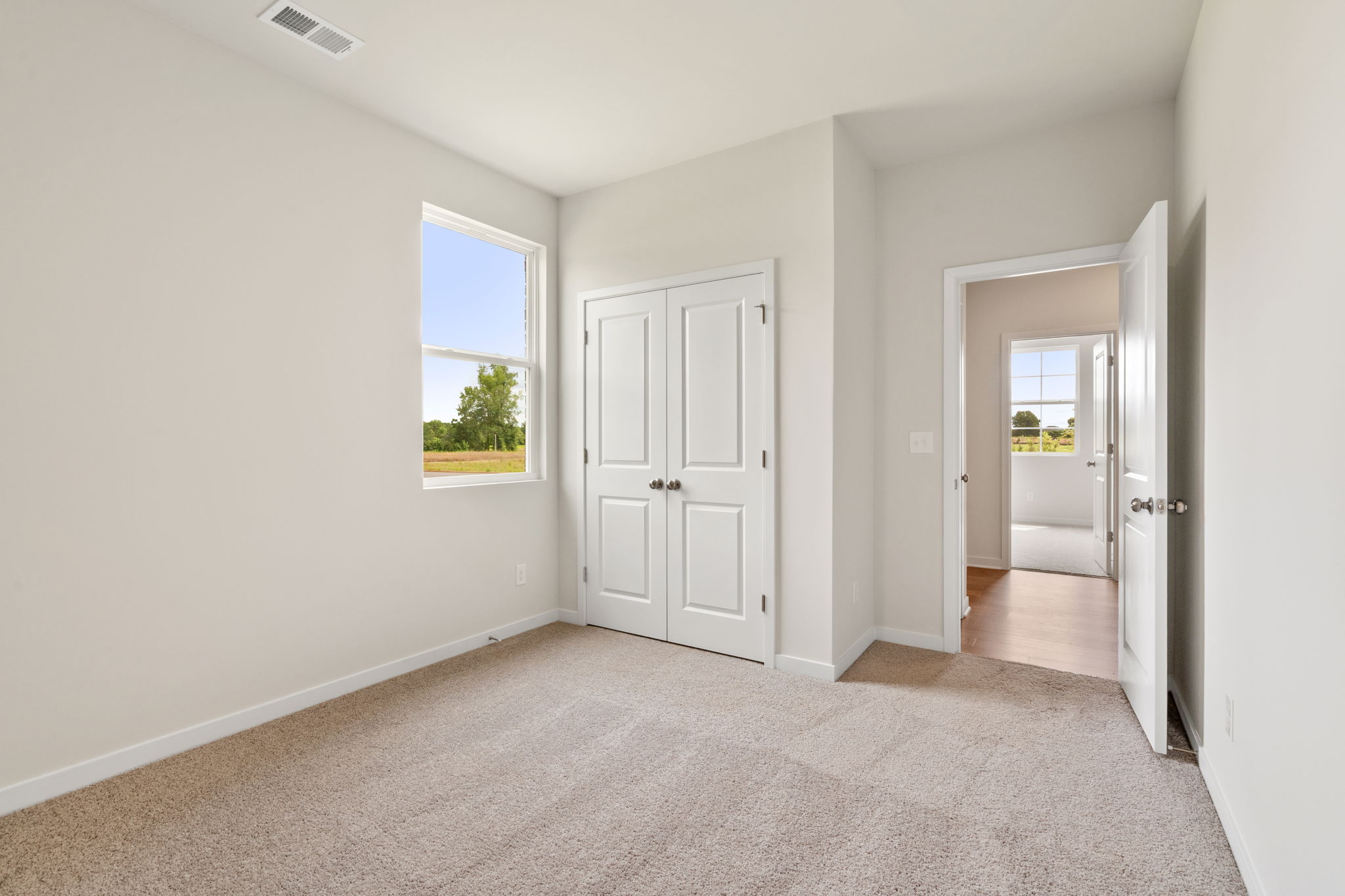 A hallway with white doors.