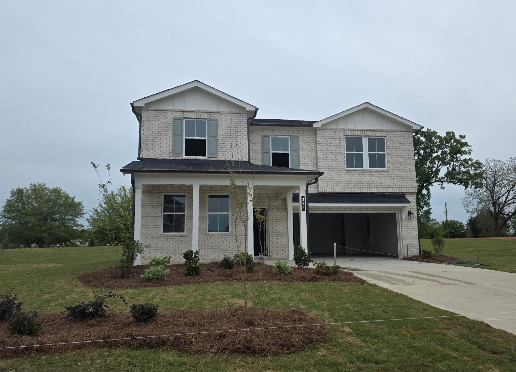 A white house with a driveway.