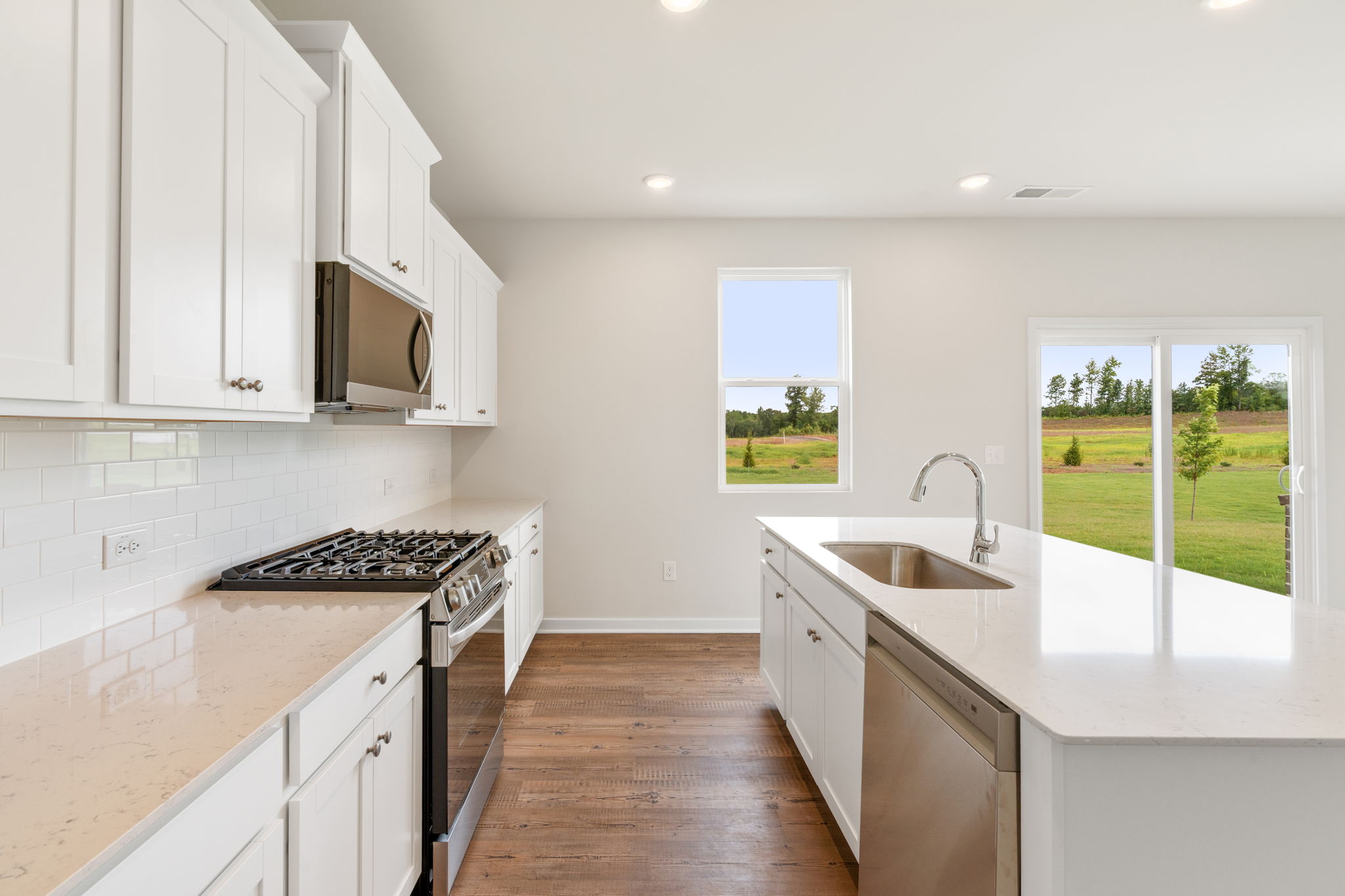A kitchen with white cabinets.