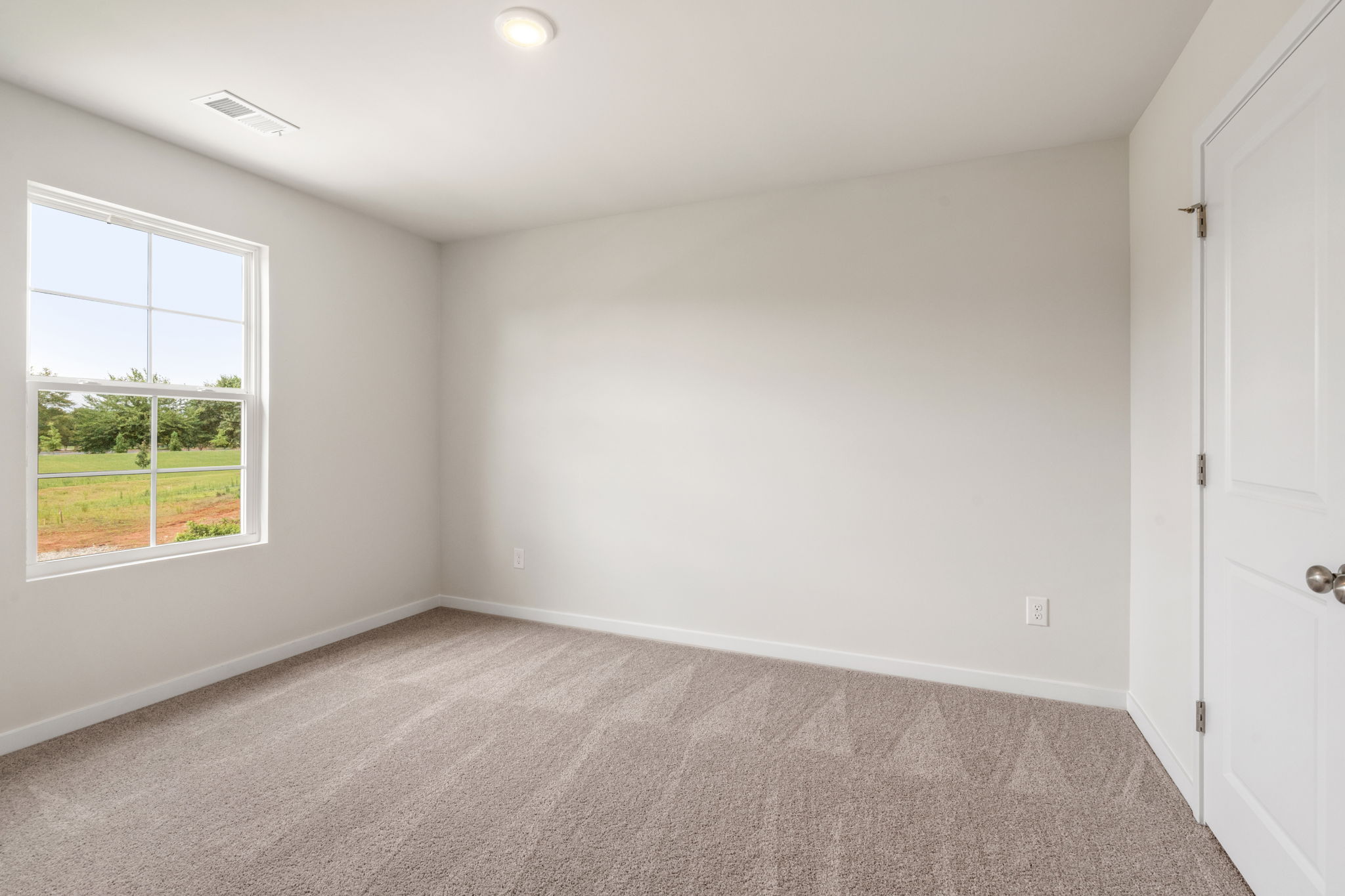 A room with a window and a door.