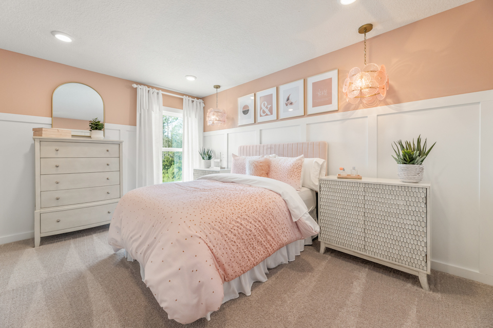 A bedroom with a bed and dresser.