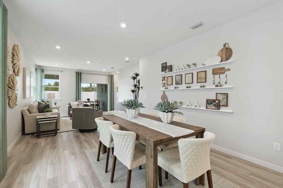A dining room with a table and chairs.