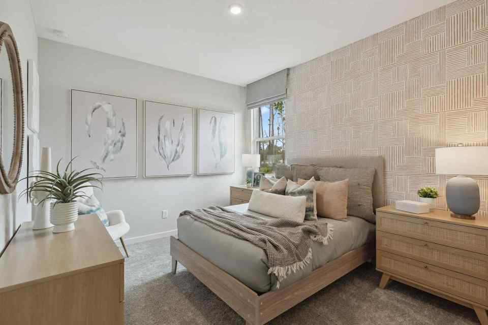 A bedroom with a bed and a desk.