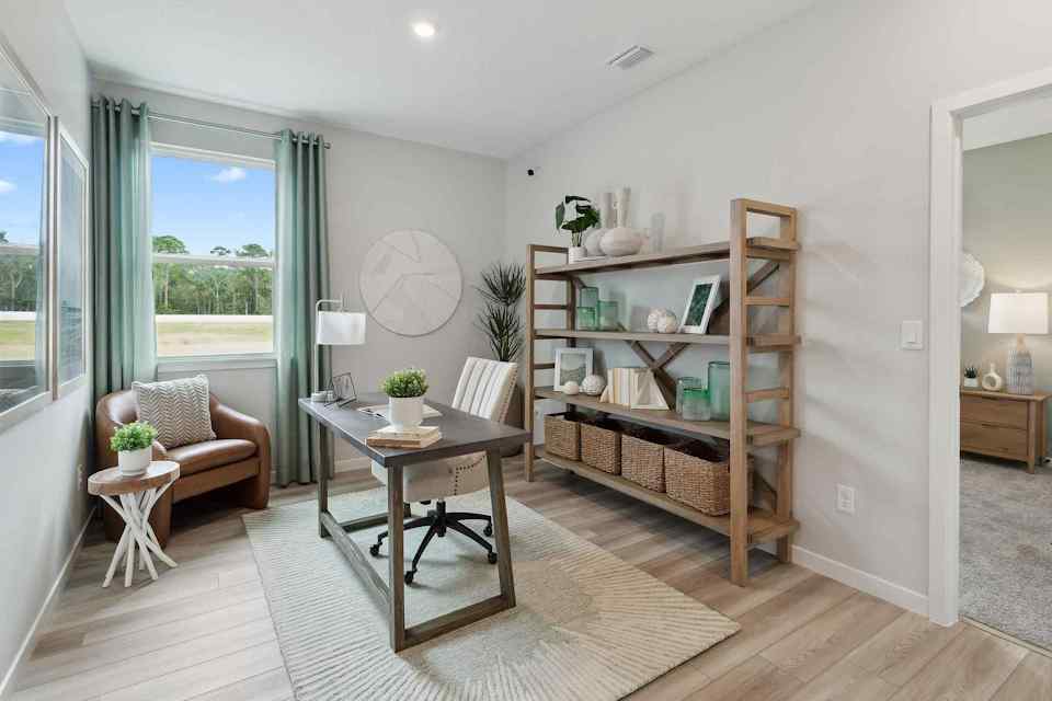 A living room with a bookcase and a table.