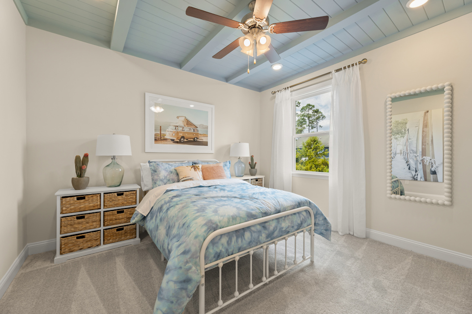 A bedroom with a bed and a fan.