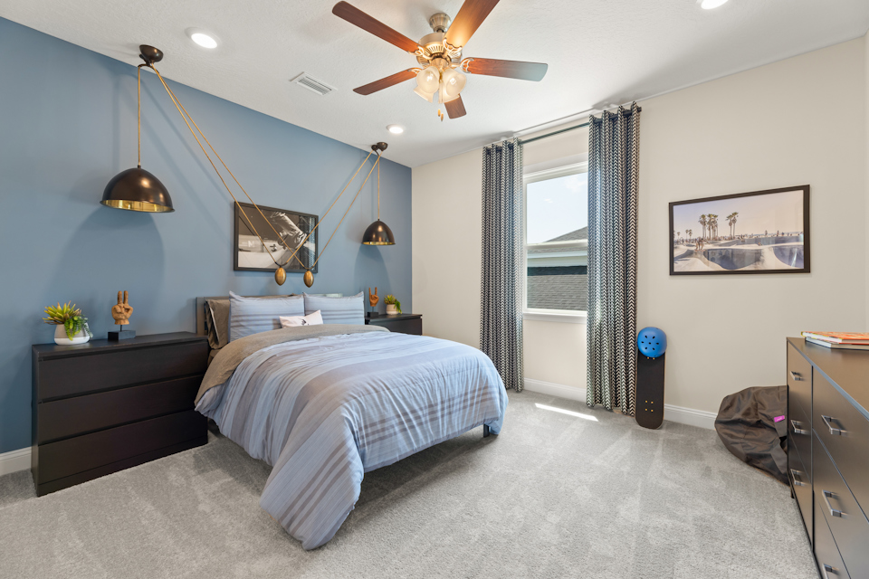 A bedroom with a bed and a fan.