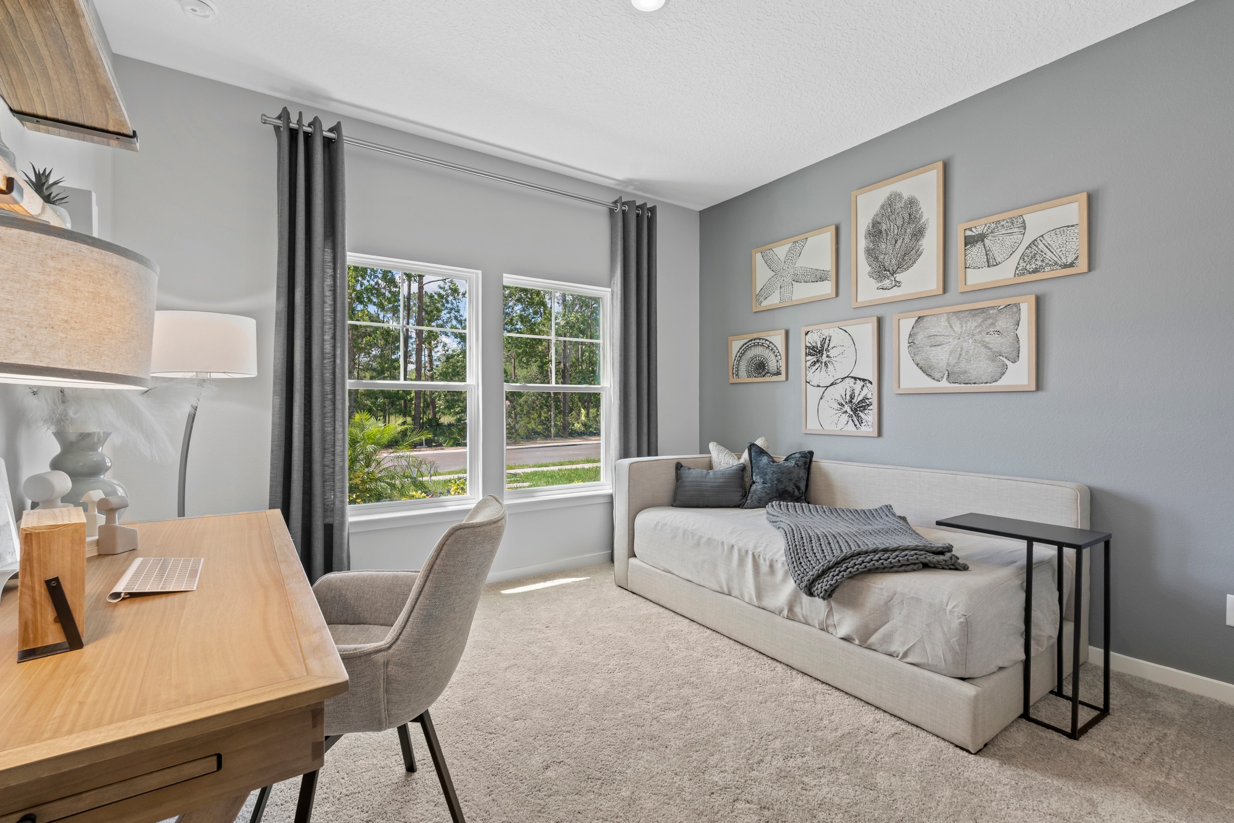 Coronado Model Home Guest Bedroom with Daybed and Desk at Reserve East in Flagler Beach