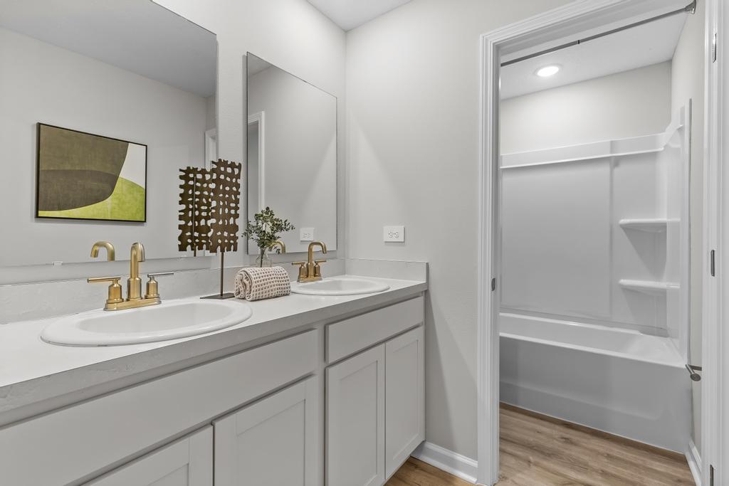 A bathroom with a sink and a shower.