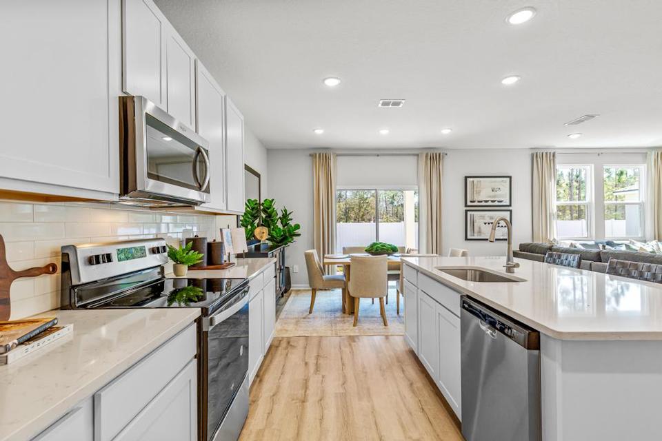 A kitchen with white cabinets.