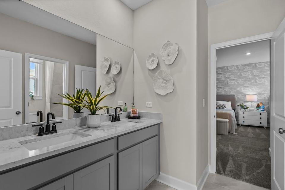 A bathroom with a sink and a mirror.