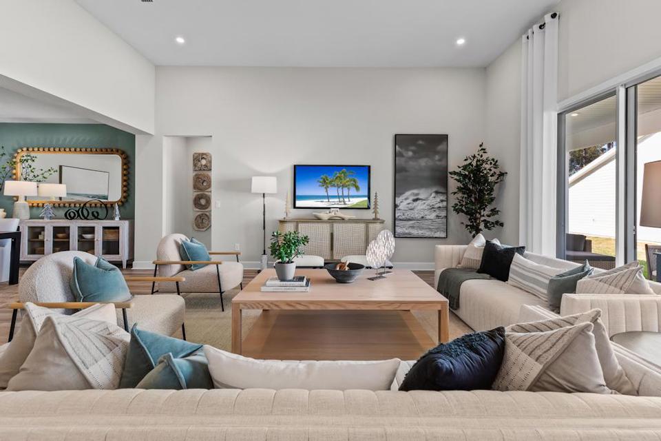 A living room with a large television.