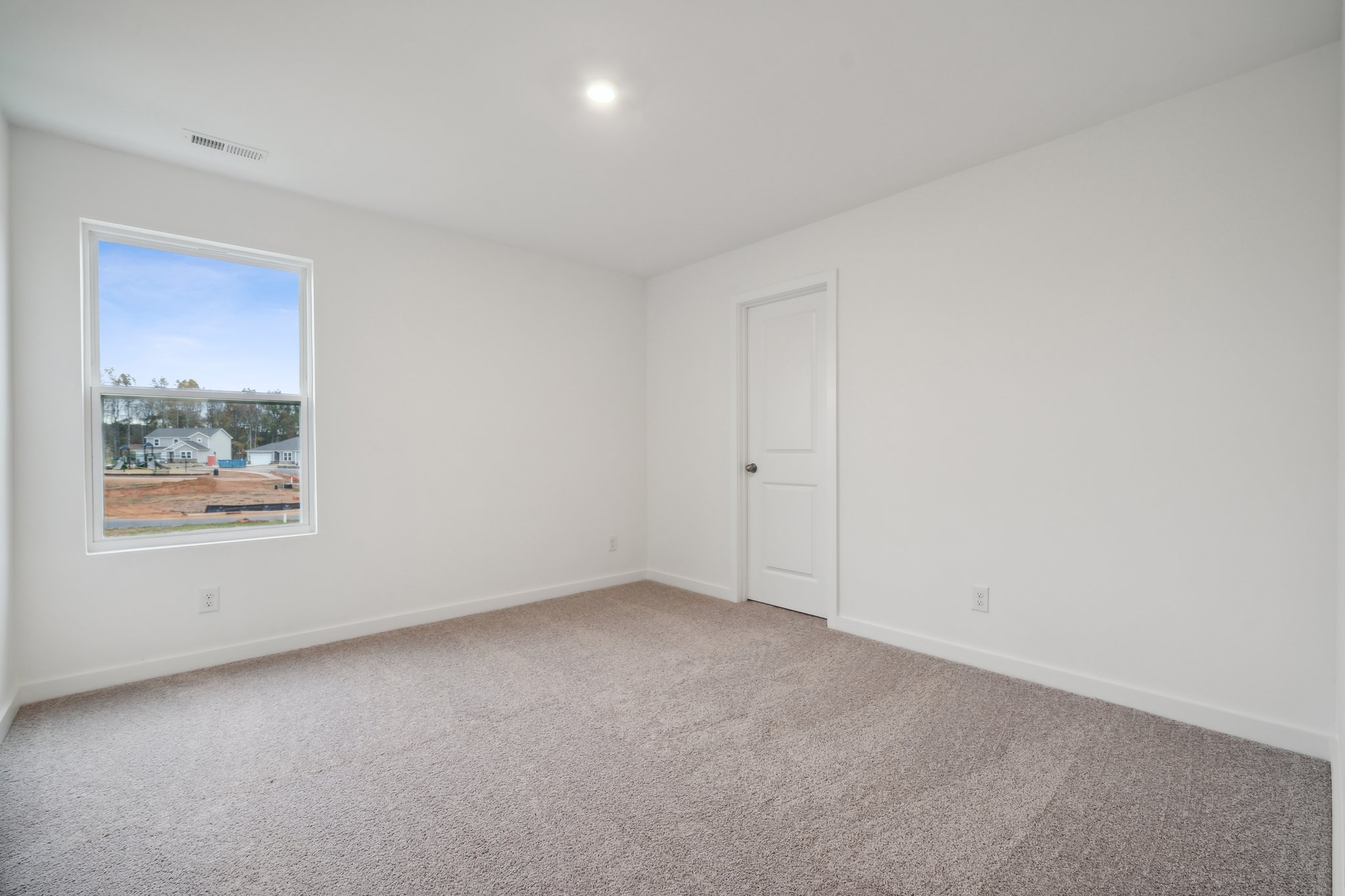 A room with a window and a door.