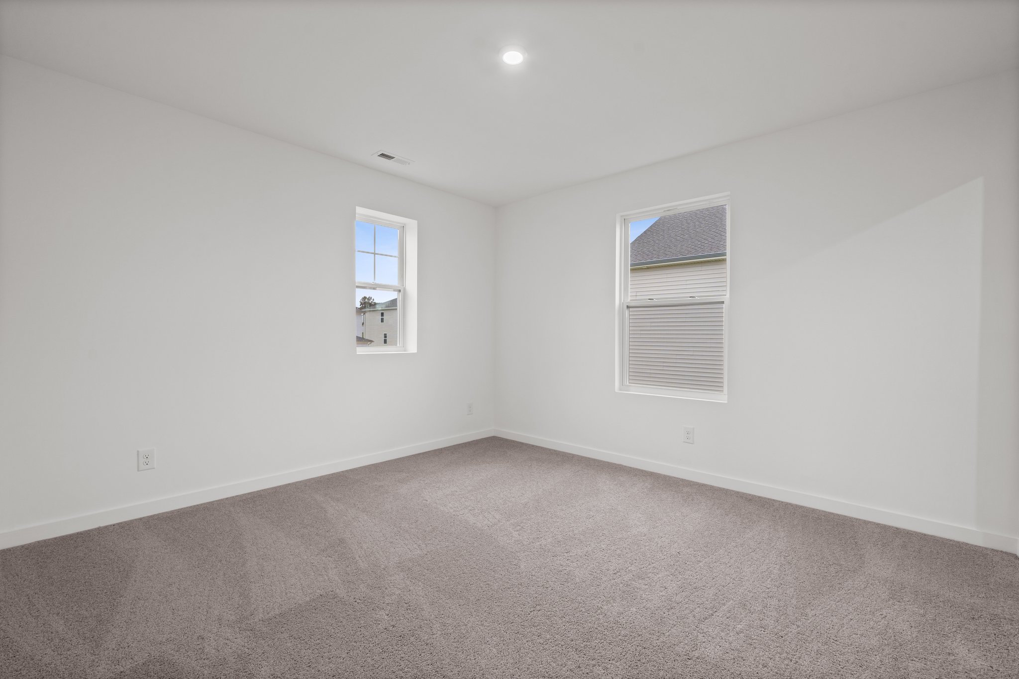 A room with a window and a carpet.